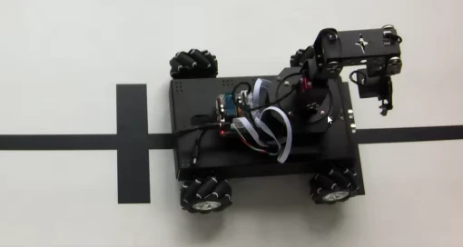 The mobile robotic arm positioned on a marked test surface.